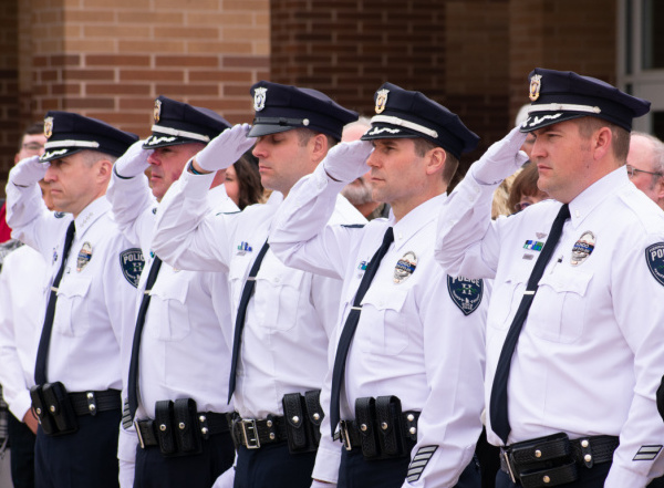 Five Herriman Police officers salute during a memorial service for K9 Hondo in February 2020