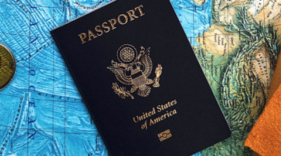 Picture of the cover of a U.S. passport next to a map.