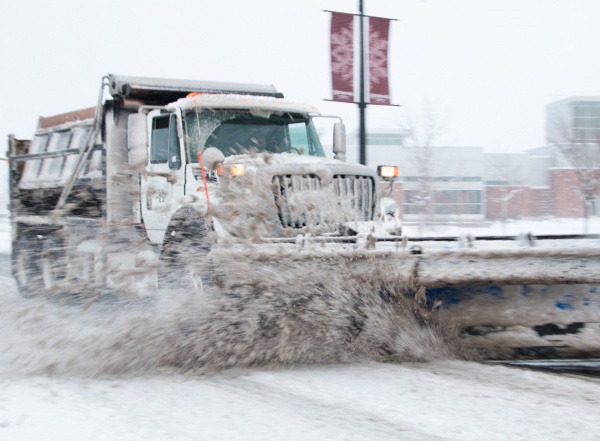 A Herriman snowplow clears Main Street during a February 2019 snowstorm