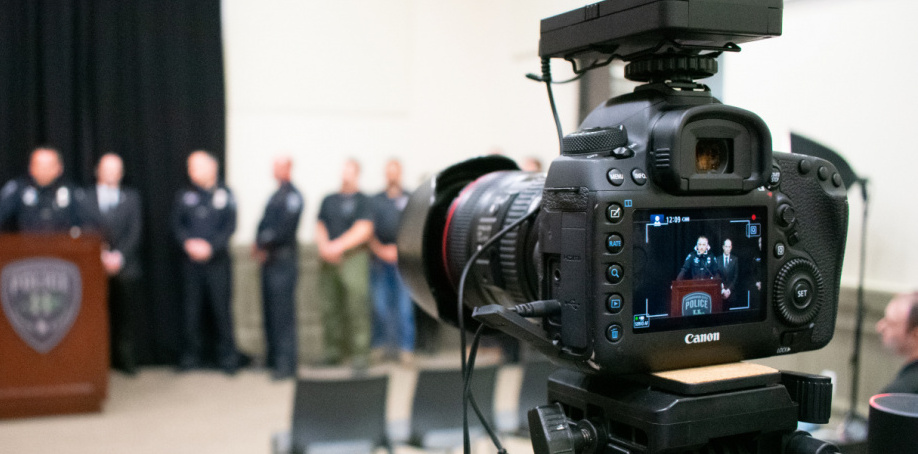Image of a camera during a police department press conference