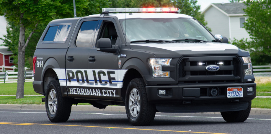 A Herriman Police truck on a parade route at the end of the 2019 Fort Herriman Towne Days parade