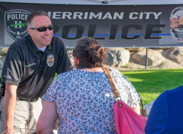 Herriman Chief of Police Troy Carr talks with a resident at Fort Herriman Towne Days 2018