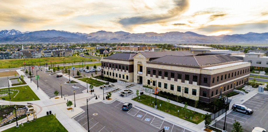 The Herriman City Hall is decorated with a sunset behind nearby mountains