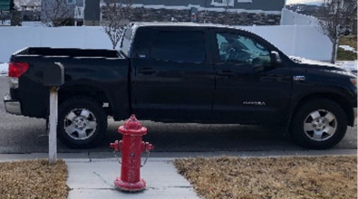 Vehicle parked in front of a fire hydrant and mailbox