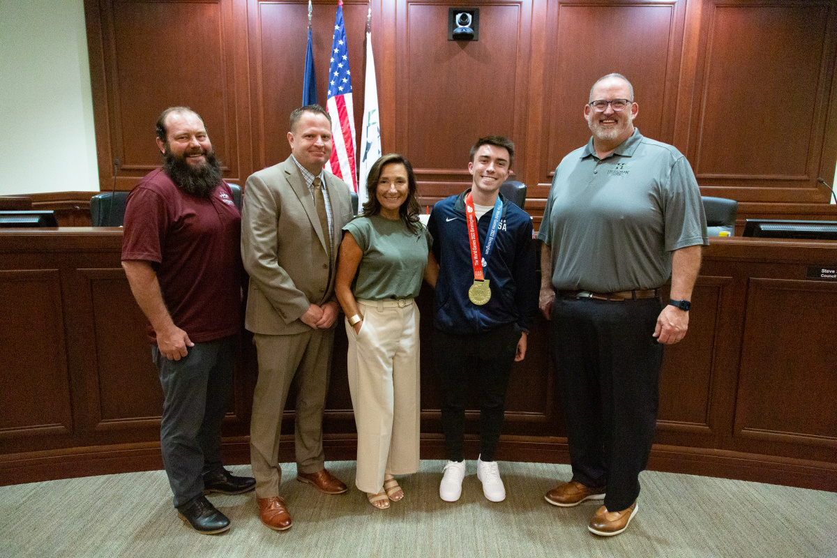 World Champion (men's tumbling) Kaden Brown and his mother stand with the City Council (August 10, 2022)