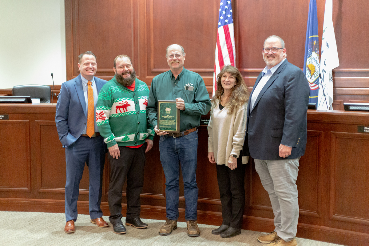 Herriman City Arborist Trent Bristol stands with the City Council while being recognized for receiving the Utah Arborist of the Year award.