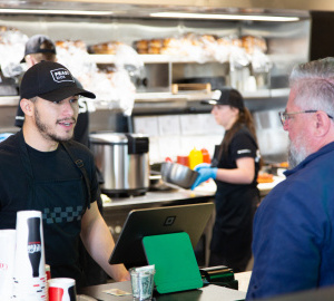 An employee at FEASTbox helps a customer.