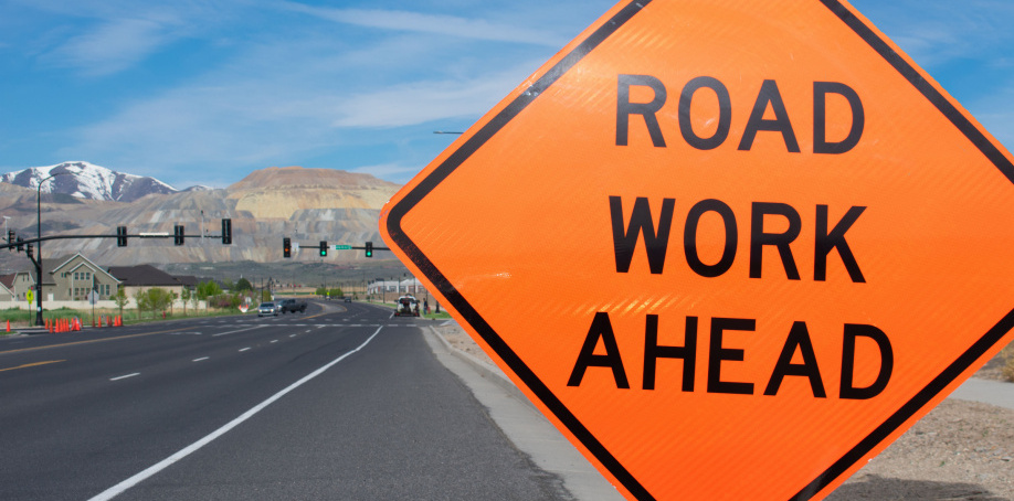 Construction sign with text Road Work with road in the background