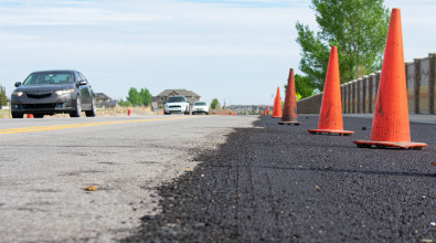 The first stage of an asphalt pavement preservation treatment on a Herriman road in 2020
